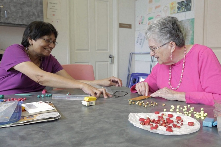 An image of two older adult participants engaging in artmaking.